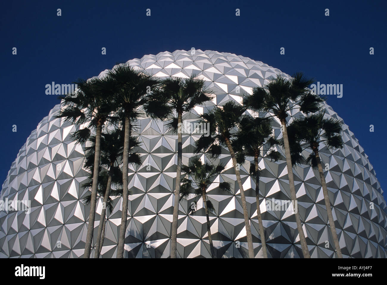 The exterior of the geosphere Spaceship Earth at the entrance of Epcot Center Disney World in Orlando Florida with palm trees  Stock Photo