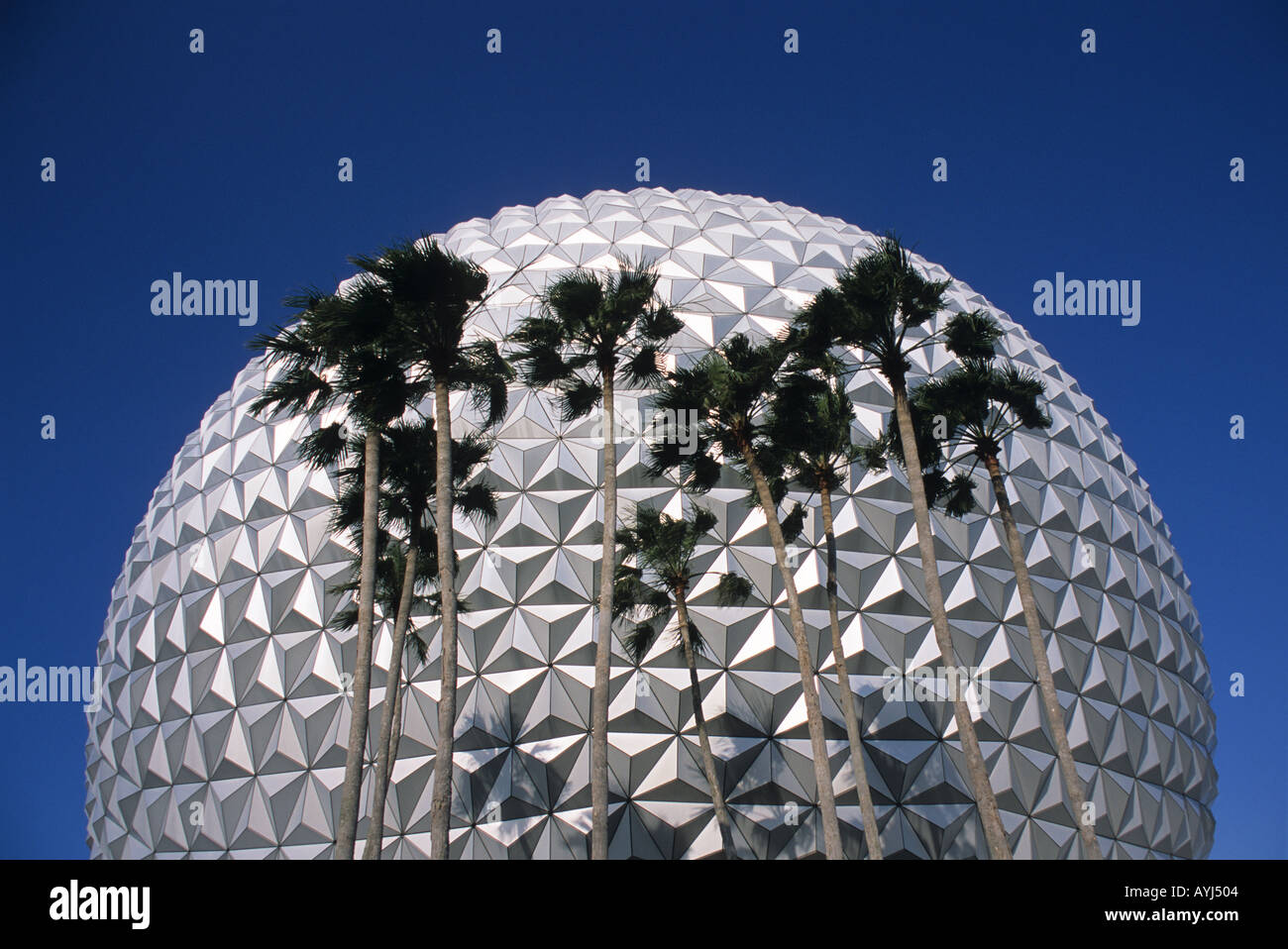 The exterior of the geosphere Spaceship Earth at the entrance of Epcot Center Disney World in Orlando Florida with palm trees  Stock Photo