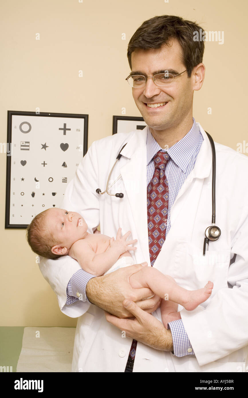 A pediatrician doctor performs a newborn medical examination. Stock Photo