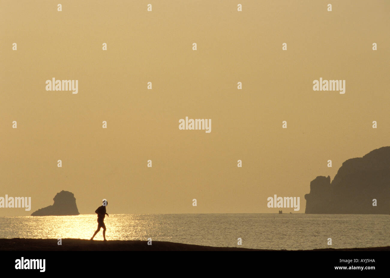 Costa Brava Estartit a late afternoon jogger on the beach Stock Photo
