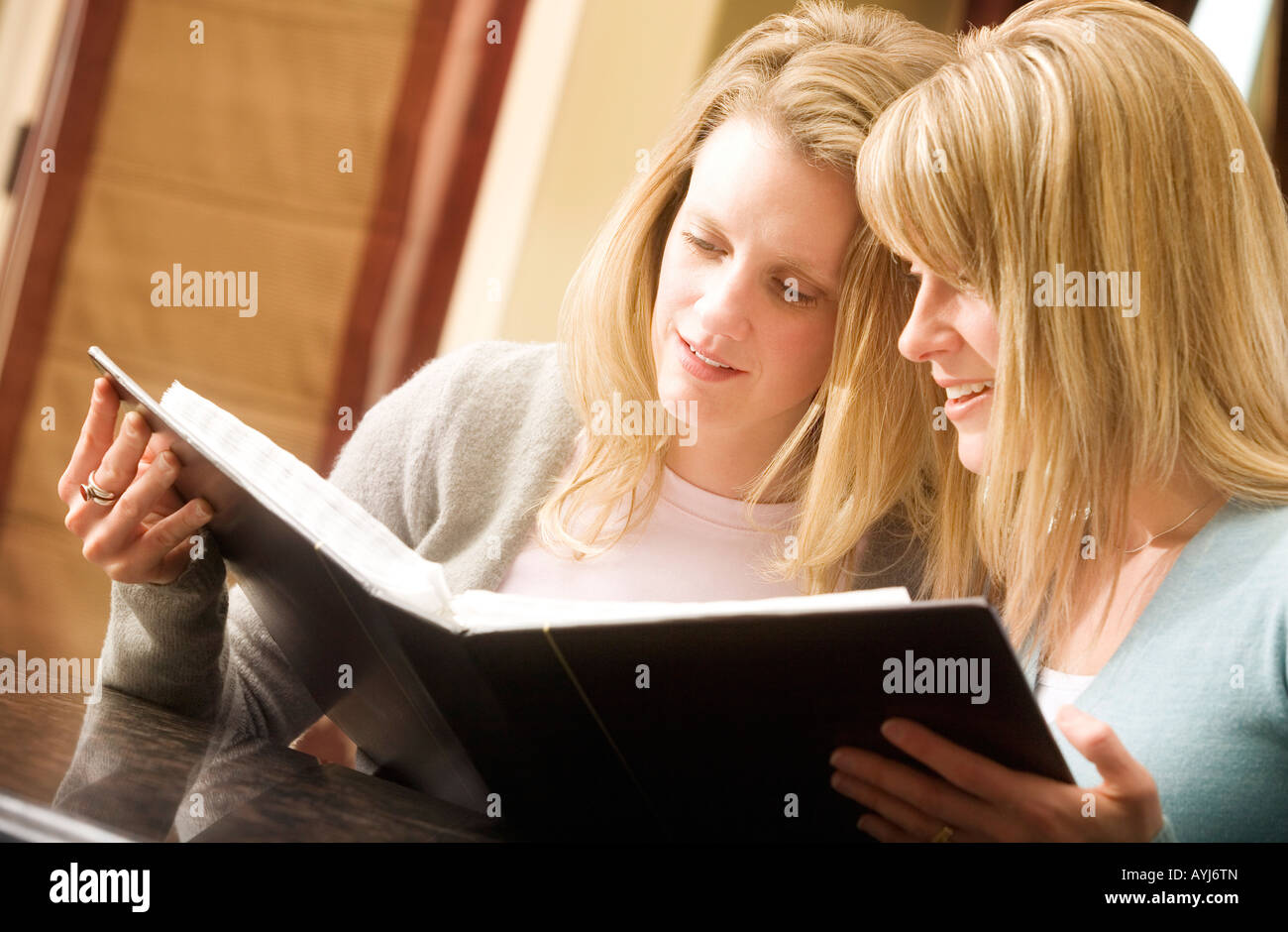 Women looking at photo album Stock Photo