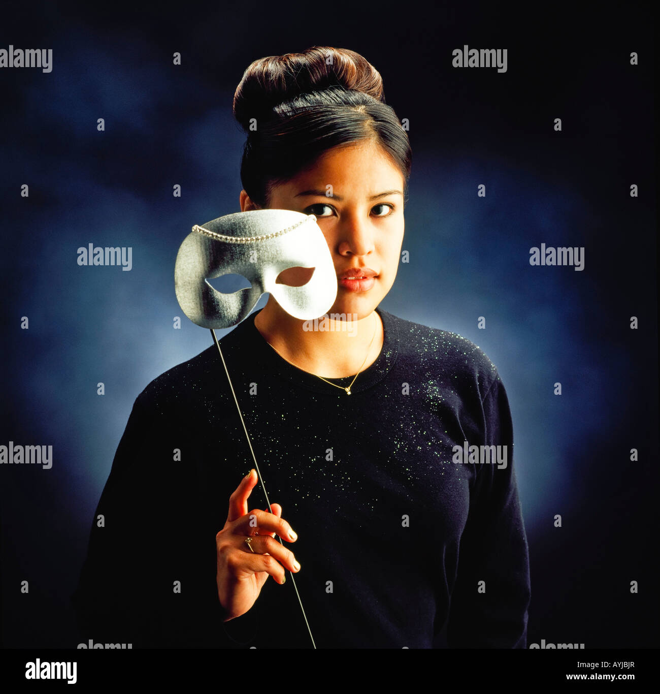 Woman holding mask Stock Photo Alamy