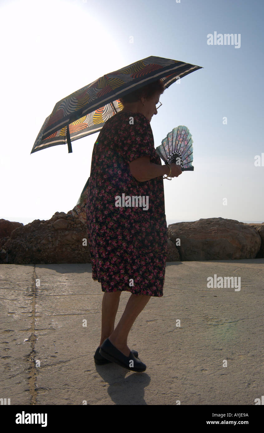Lady shading the sun with umbrella hires stock photography and images