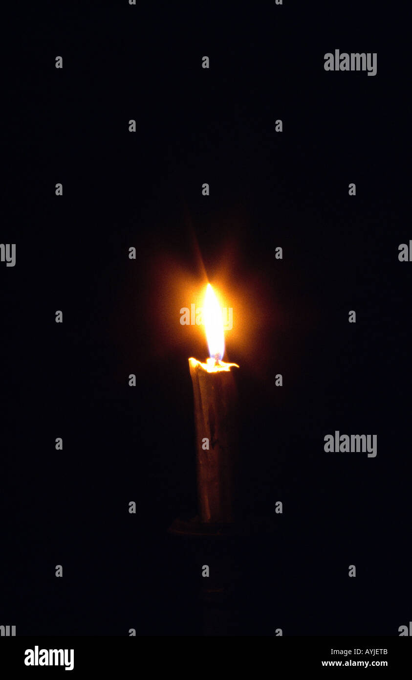 Glowing Candle In The Darkness Stock Photo Alamy