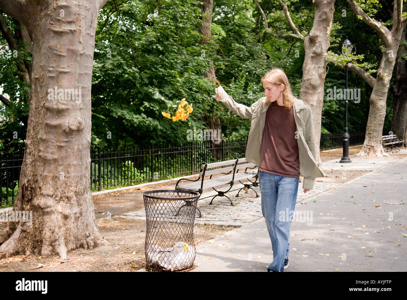 young Caucasian boy disheartened throwing away flowers Stock Photo Alamy