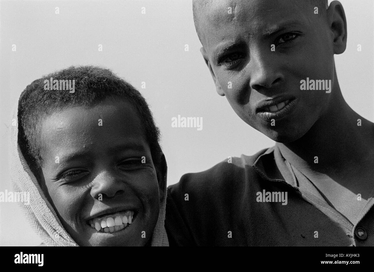 B/W portrait of two rural boys, one laughing, the other frowning. Mekoni, Tigray, Ethiopia, Africa Stock Photo
