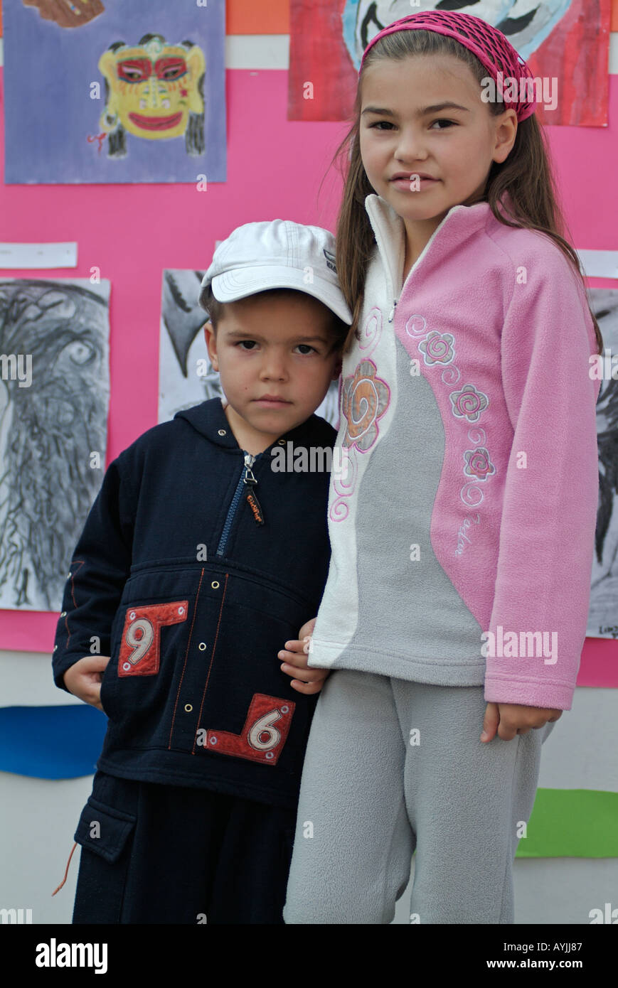 Brother and sister at a display of art by school children Stock Photo