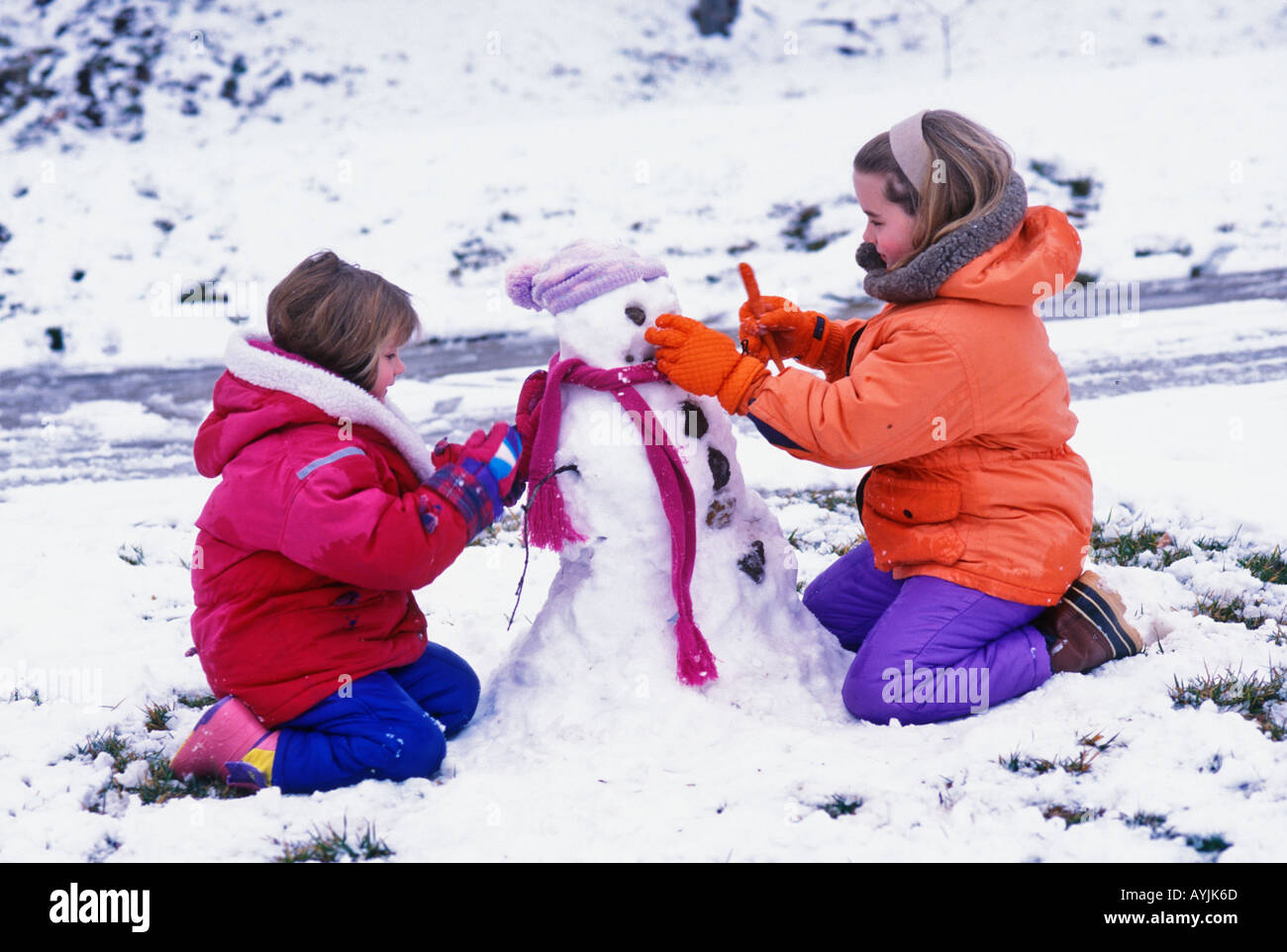 Two Sisters Building Snowman in Southern Indiana Stock Photo