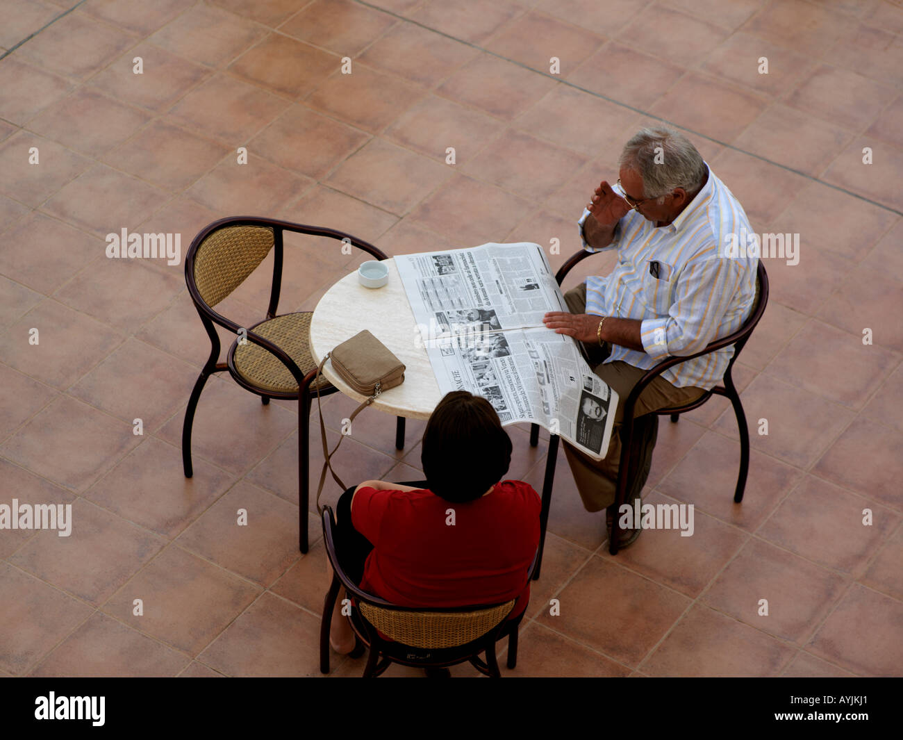 Palermo Sicily Italy Genoardo Park Hotel Reading Newspaper on Terrace Couple Sitting at Table Stock Photo