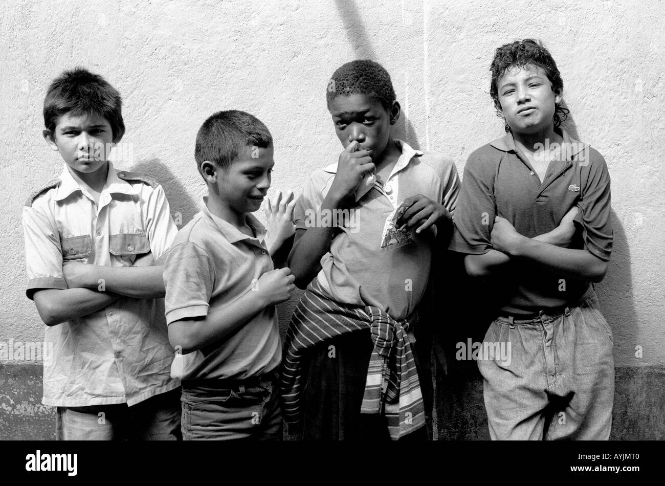 b/w of vulnerable street boys outside a hostel where they can sleep safely at night in La Ceiba, Honduras Central America Stock Photo
