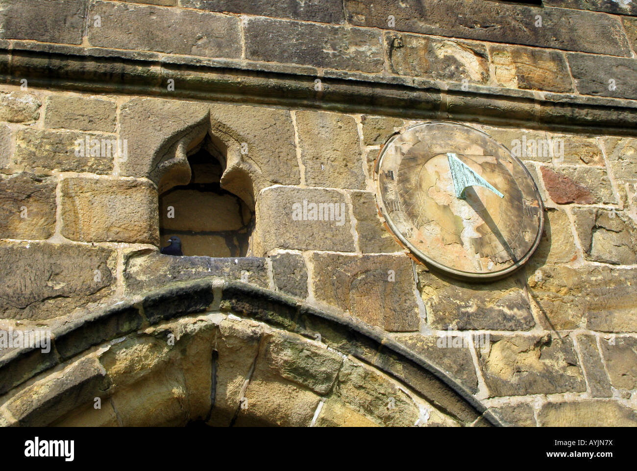 Sundial and pigeon on Bakewell All Saints church Derbyshire Peak District National park, England Stock Photo