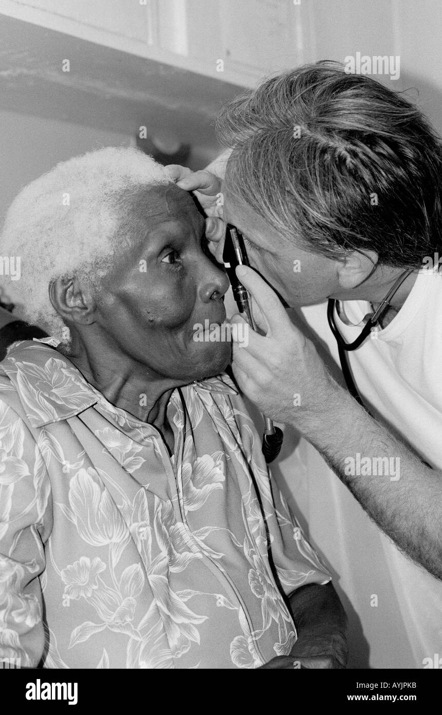 B/W of an elderly woman having an eye examination in a clinic in Kingston, Jamaica. Glaucoma is common in the Caribbean. Stock Photo