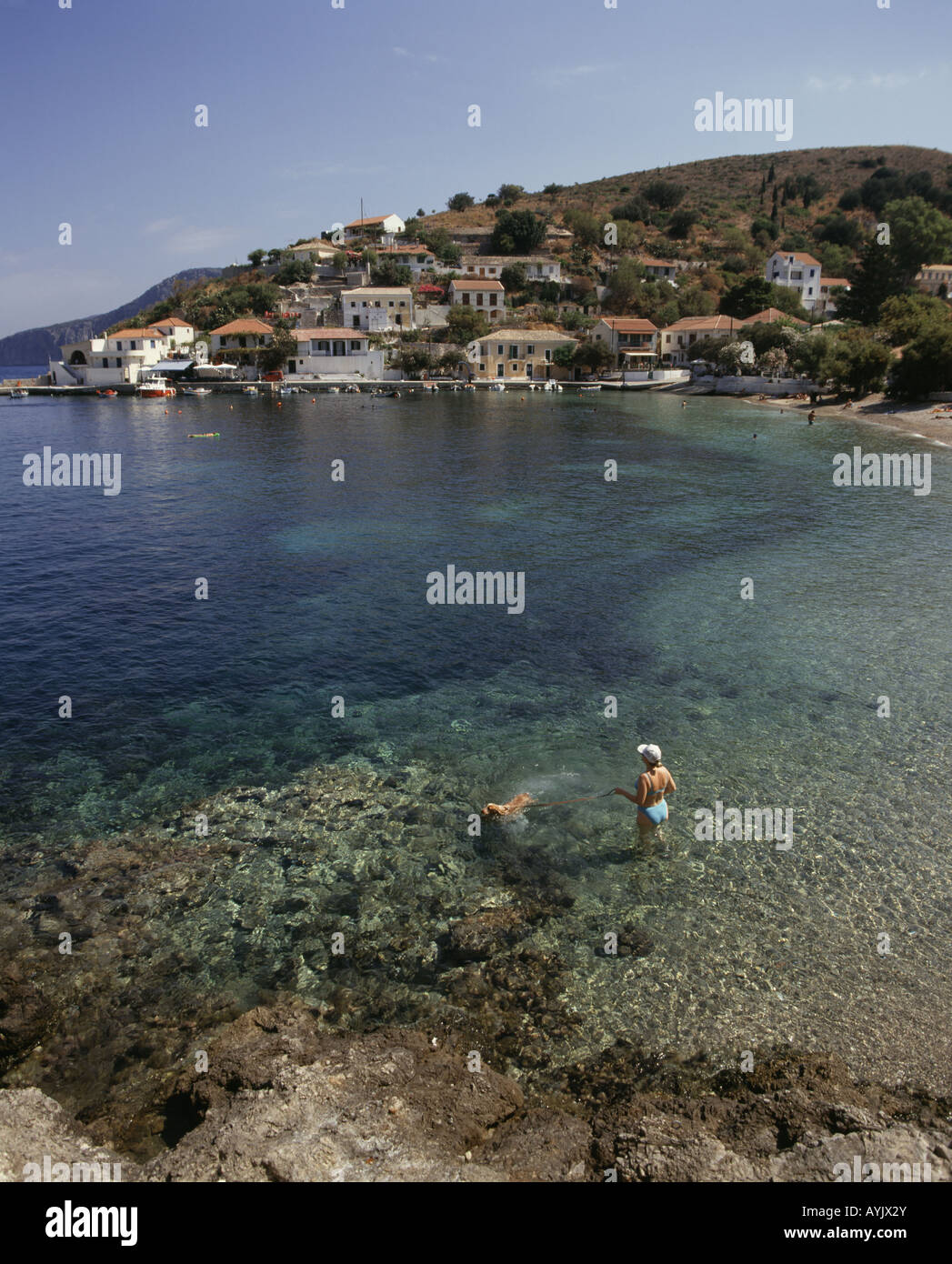 Cephallonia Ionian island Houses on shore Bay Clear water Woman Dog