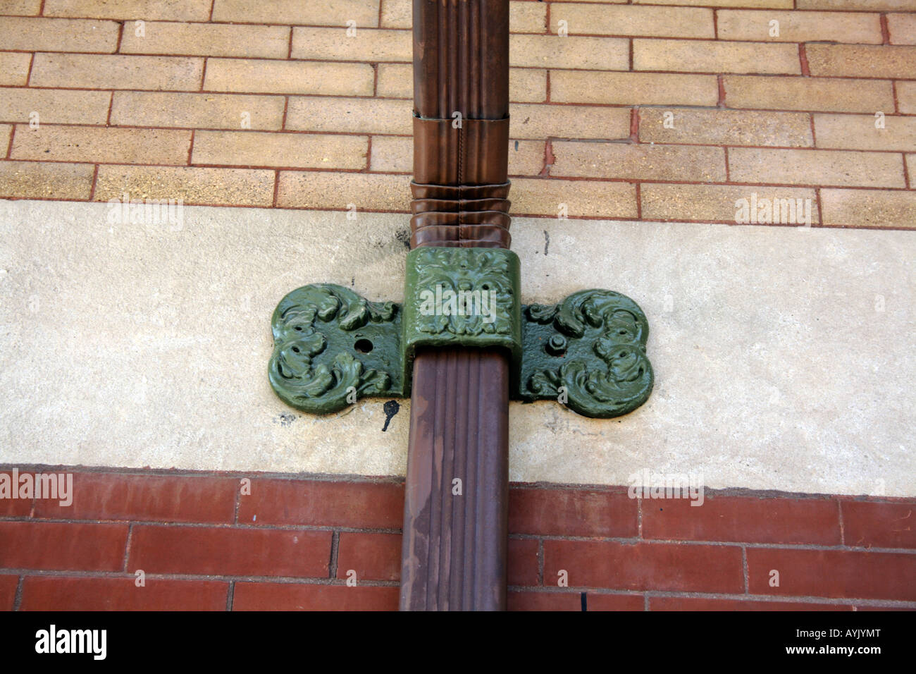 Detail of a cast iron downspout retaining strap on wall Stock Photo Alamy