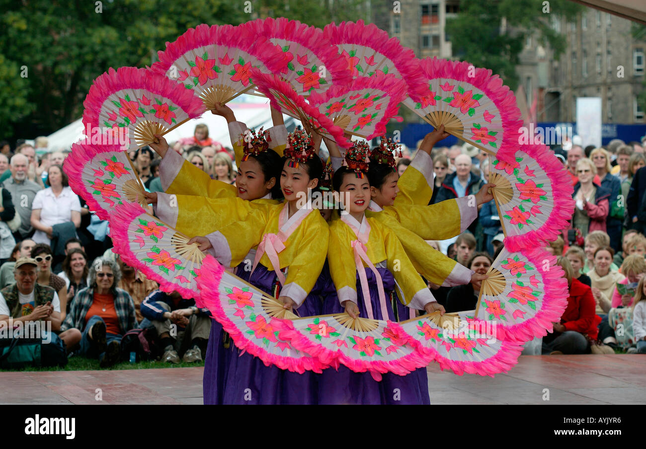 Korean dance troupe performing with fans  Edinburgh Fringe Festival Scotland Stock Photo