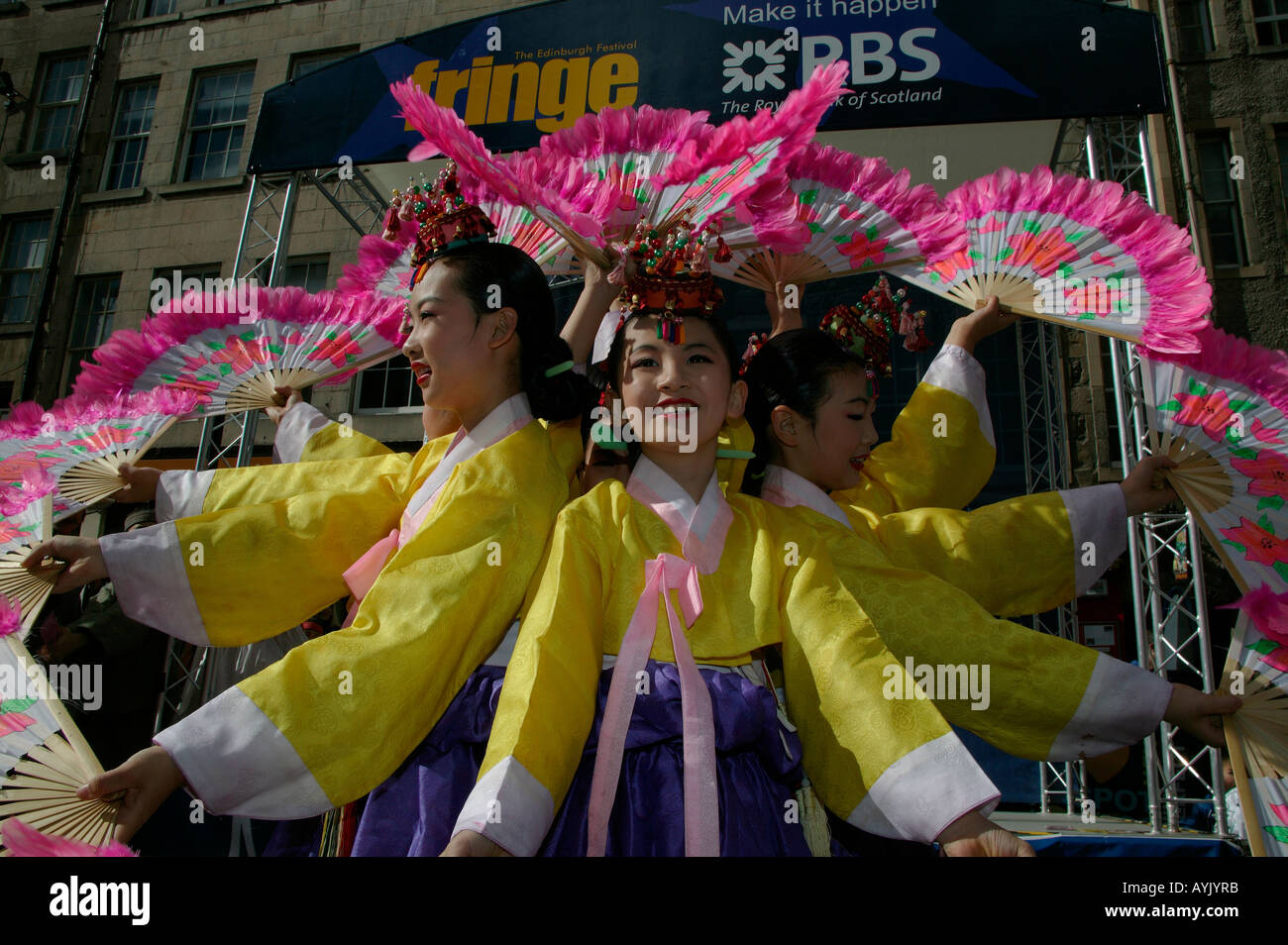 Young Korean dancers with fans promoting their stage show Edinburgh Fringe Festival, Scotland Stock Photo