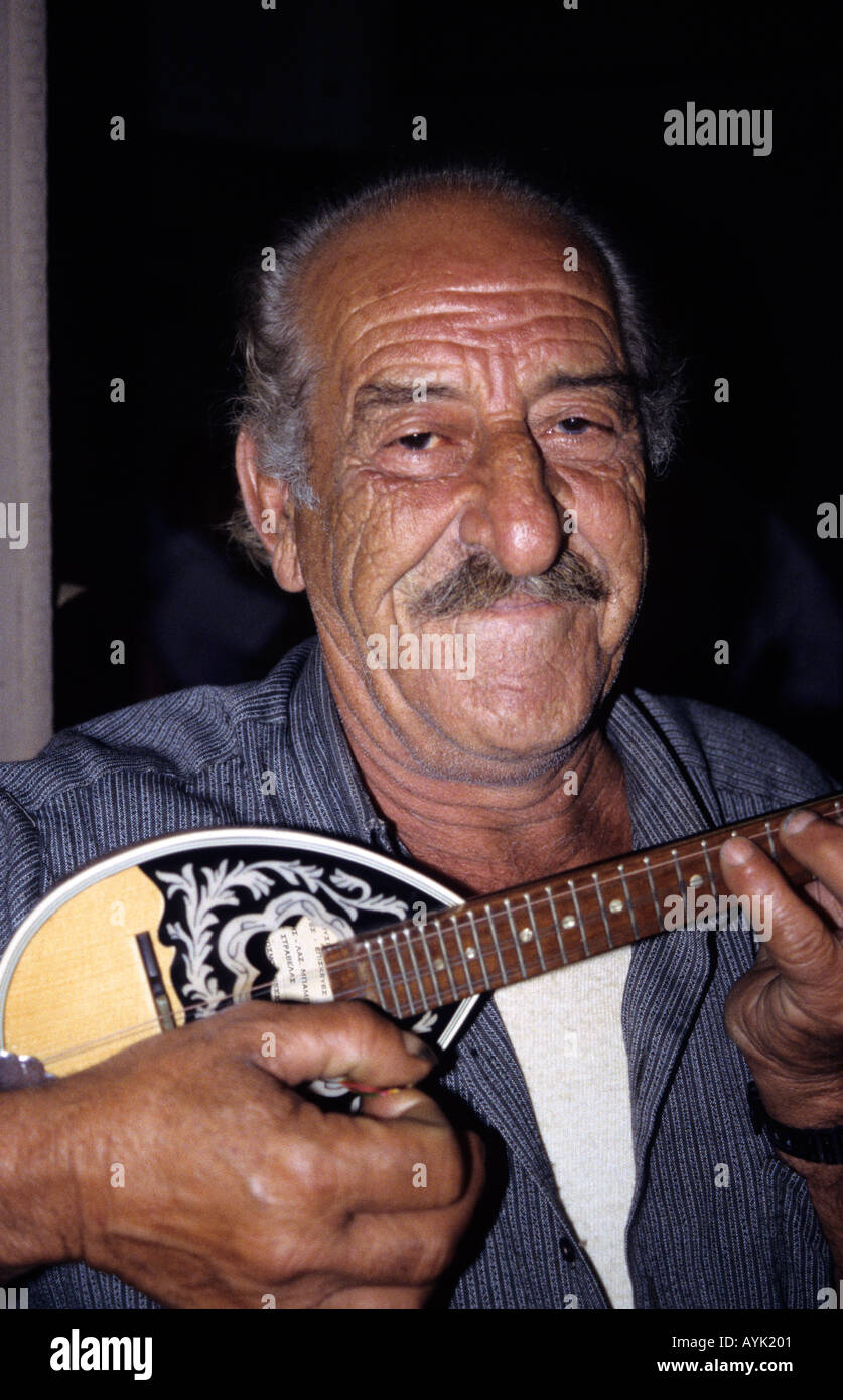greece athens an old man playing the baglama or baby bouzouki in a