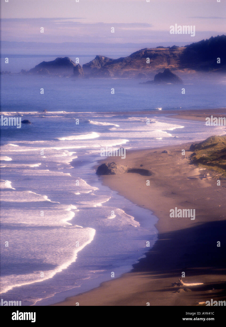 Early morning mist and fog with breaking waves on the shoreline of the Oregon coast near Cape Blanco Oregon USA Stock Photo