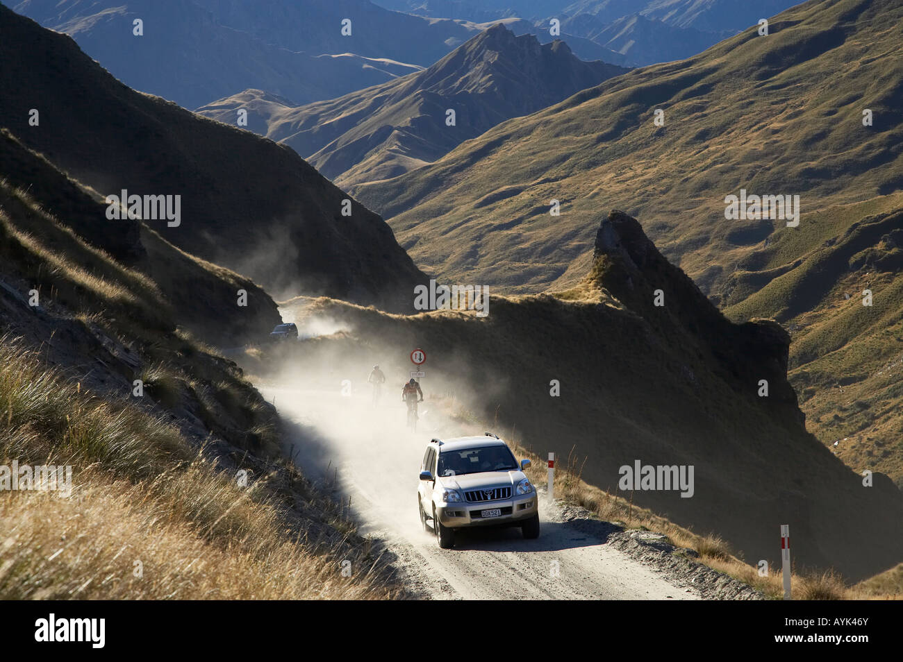Four Wheel Drive and Mountain Bikers on Infamous Road into Skippers Canyon near Queenstown South Island New Zealand Stock Photo