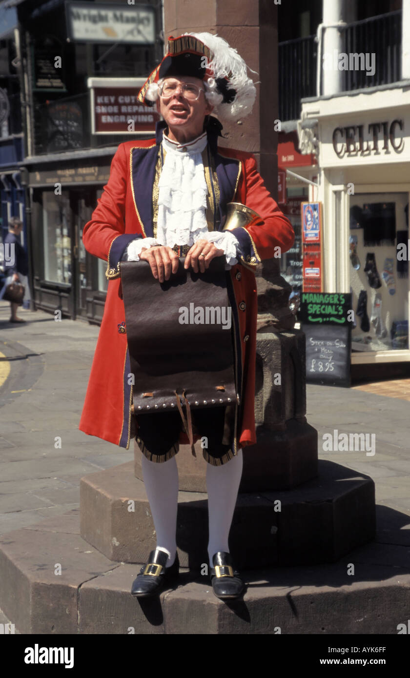 Historical city of Chester town crier wearing full regalia holding scroll & bell standing at town centre Cross in county town of Cheshire England UK Stock Photo