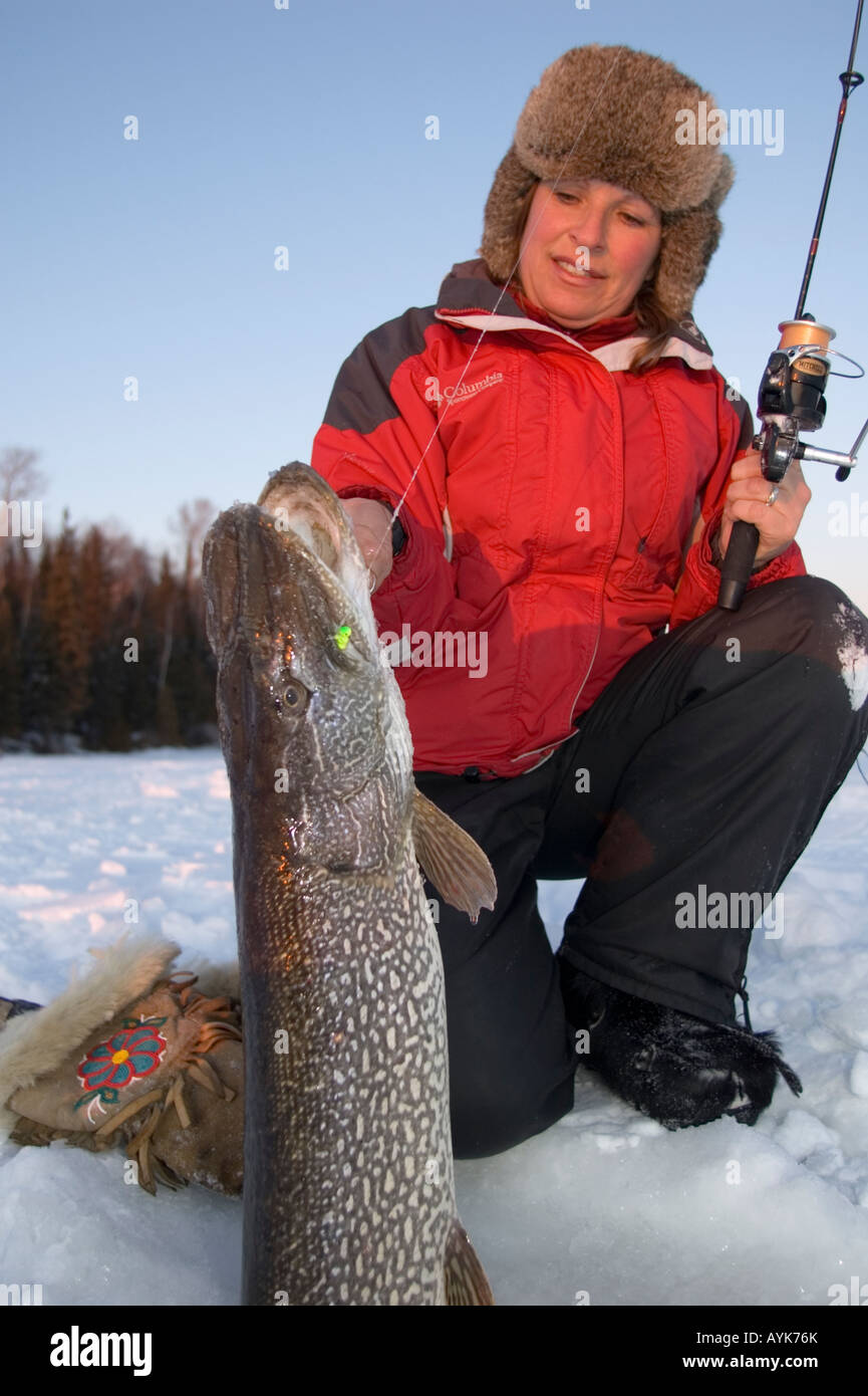 Ice fishing woman with trophy northern pike Stock Photo - Alamy