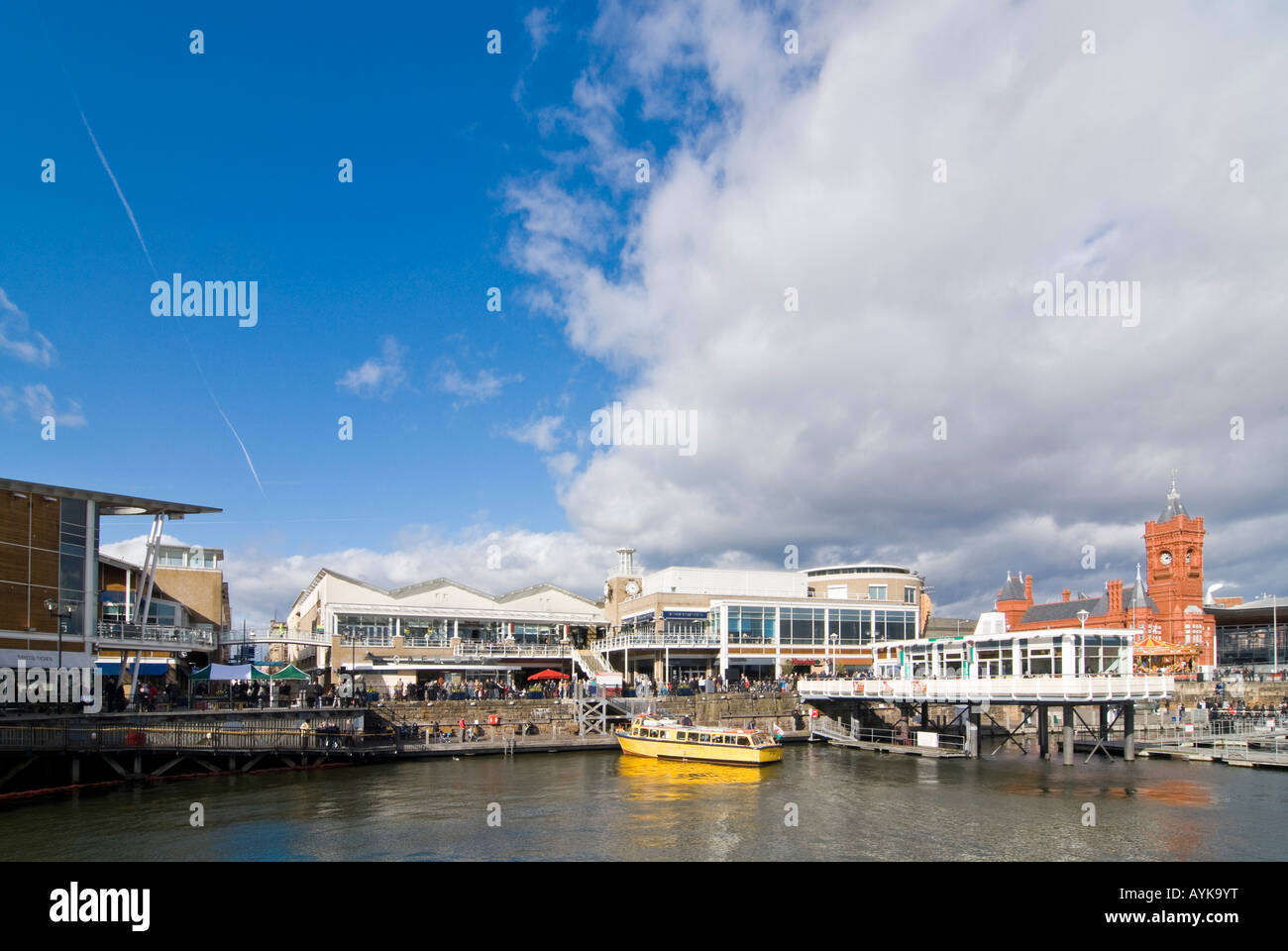 Horizontal wide angle across Mermaid Quay towards the Pierhead Building at the Cardiff Bay Development on a bright sunny day Stock Photo