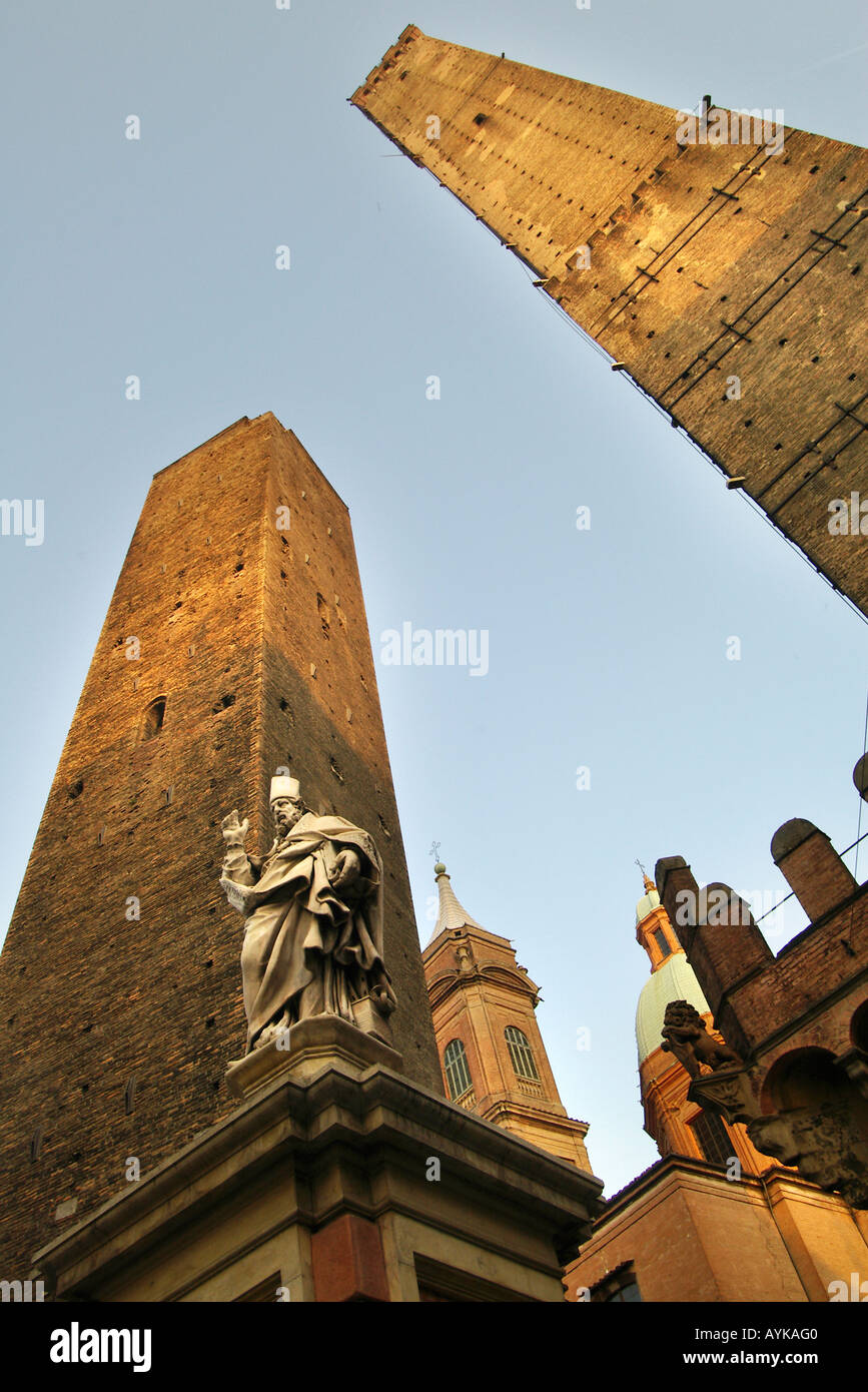 Bologna Emilia-Romagna Italy Saint San Petronious blessing the people of Bologna below the famous two towers upright vertical Stock Photo