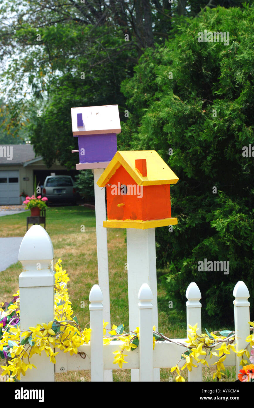 Multi-colored handmade birdhouses in a residential garden Stock ... Multi-colored handmade birdhouses in a residential garden Stock ...