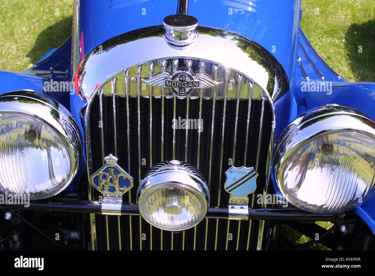 Blue chrome four plus four sports car front grille, and chrome car badge, horizontal