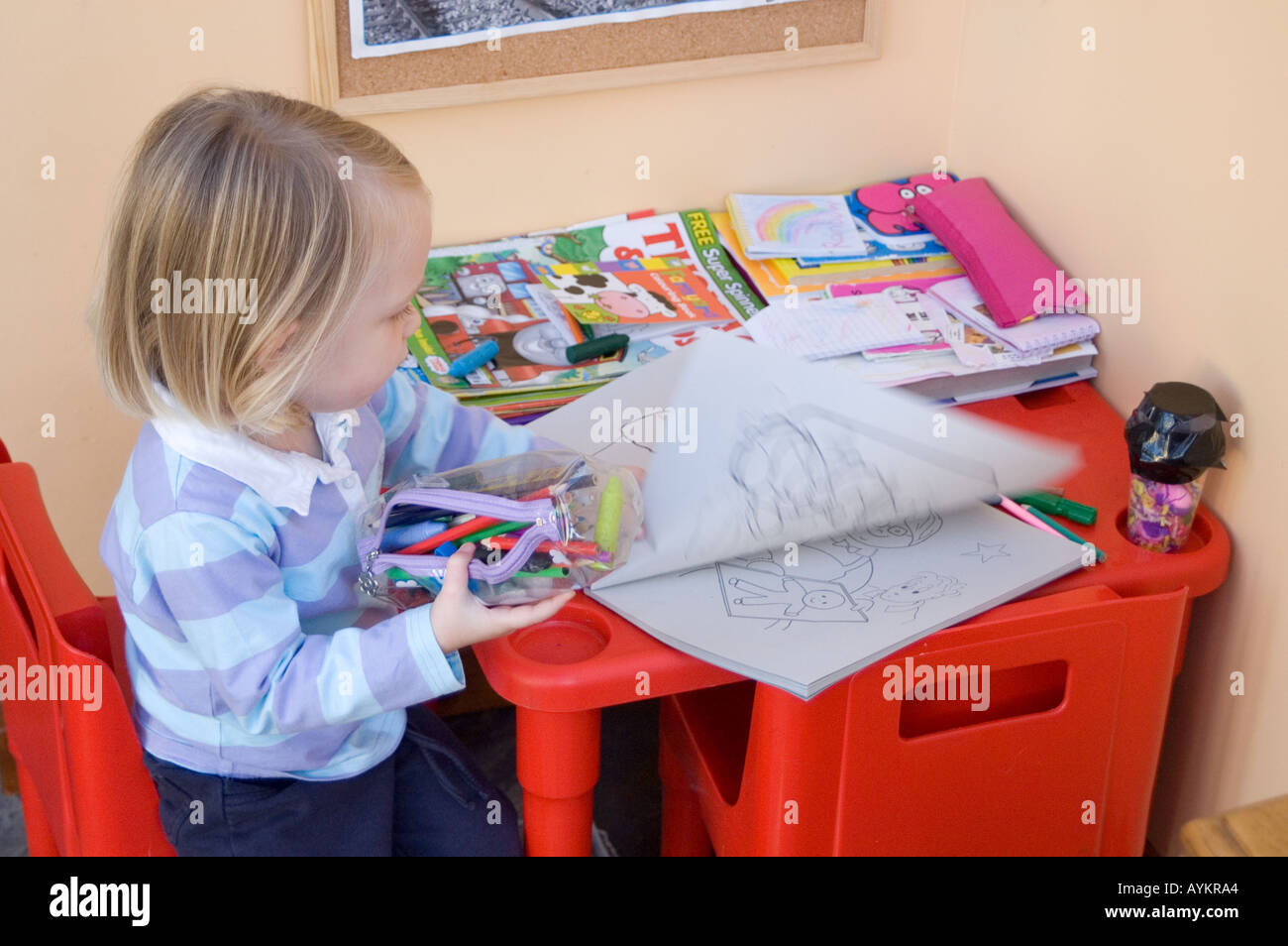 Toddler colouring at home Stock Photo