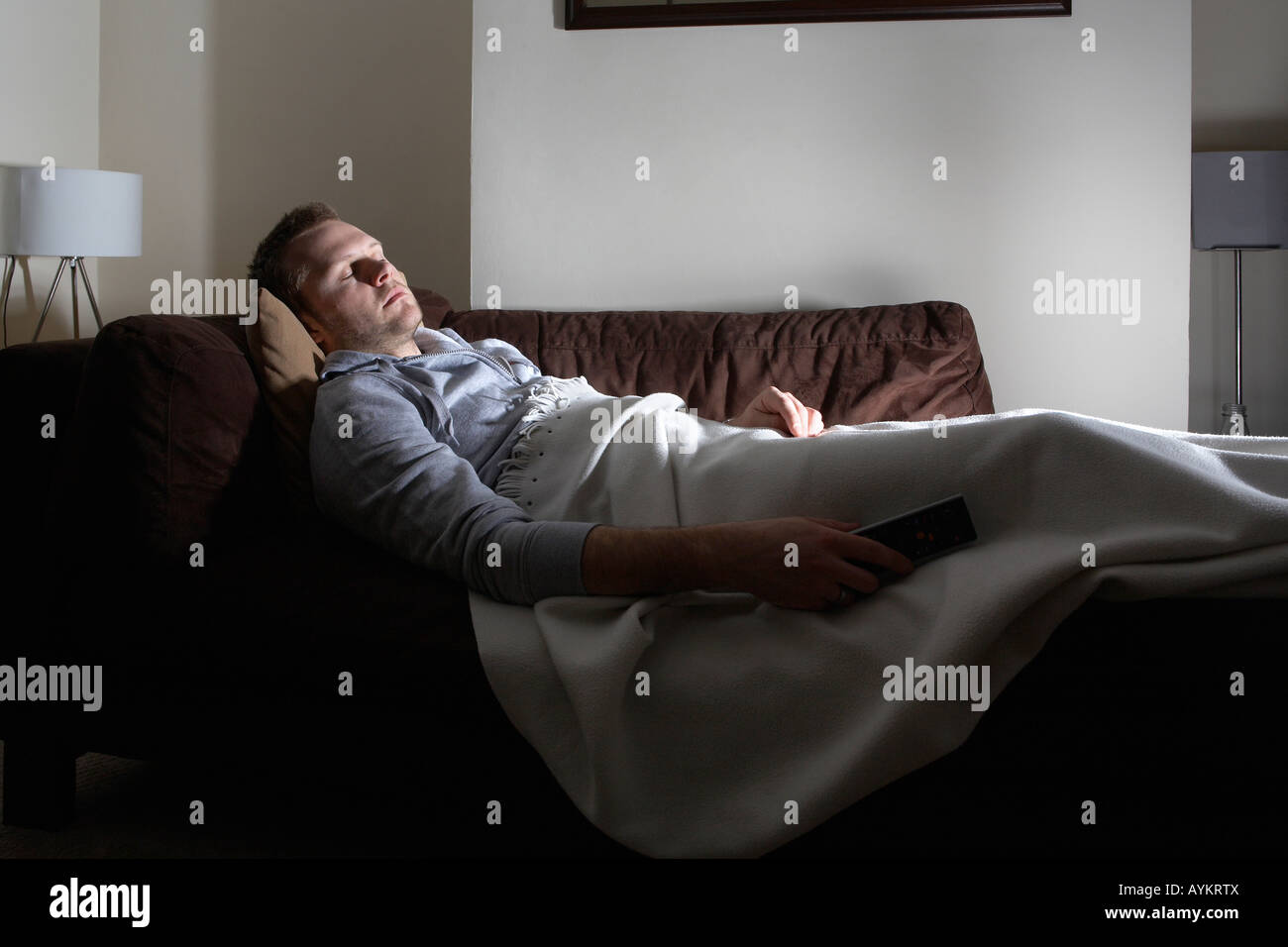 Man asleep on couch Stock Photo