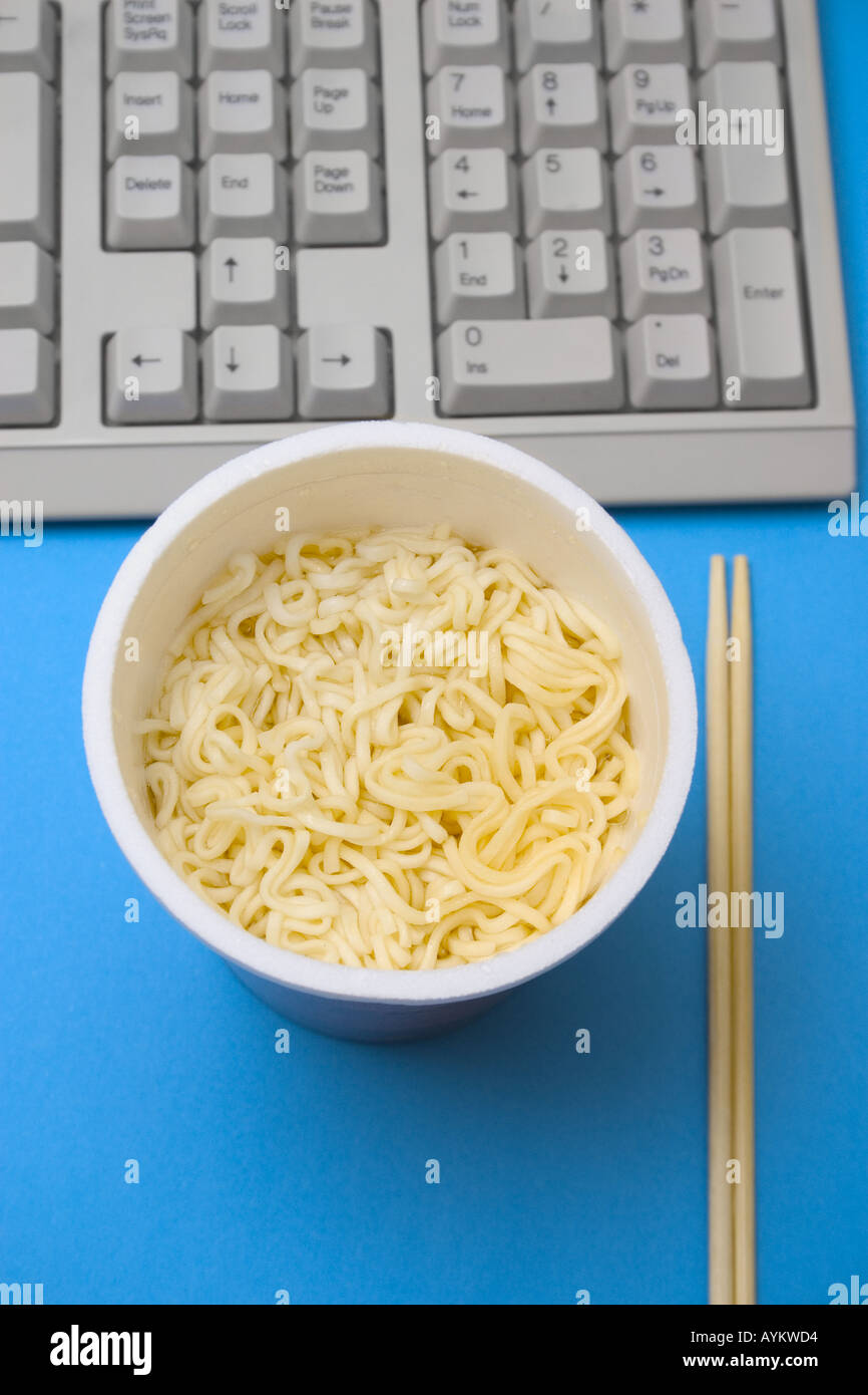 bowl of instant noodles and chopsticks on table concept busy overtime rush Stock Photo