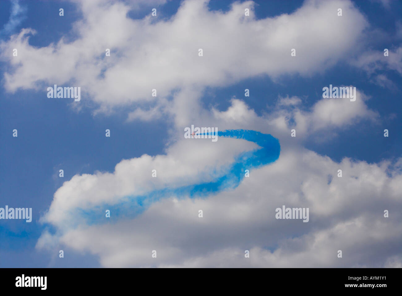 Red Arrow forming blue curve against white cloud Stock Photo