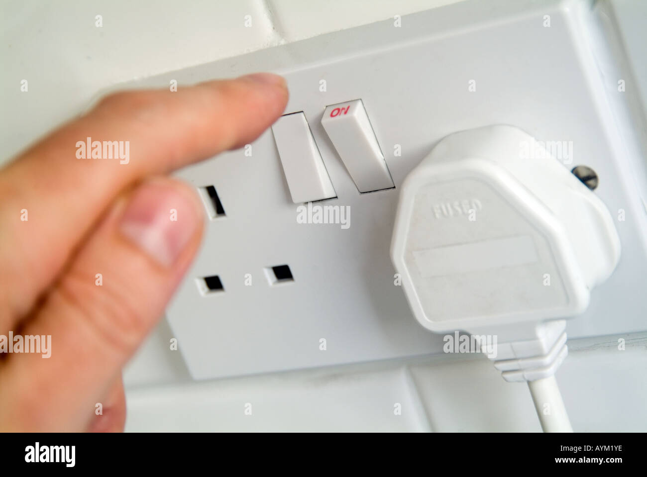 switching on an electrical wall socket Stock Photo Alamy