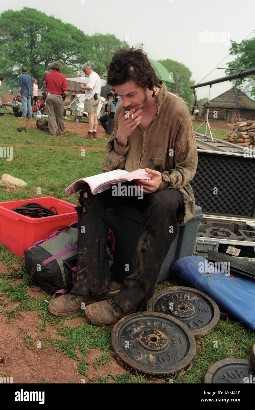 Actor Noah Taylor studying his script on the filmset of 'Simon Magus' being shot near Llangynidr Powys South Wales UK Stock Photo