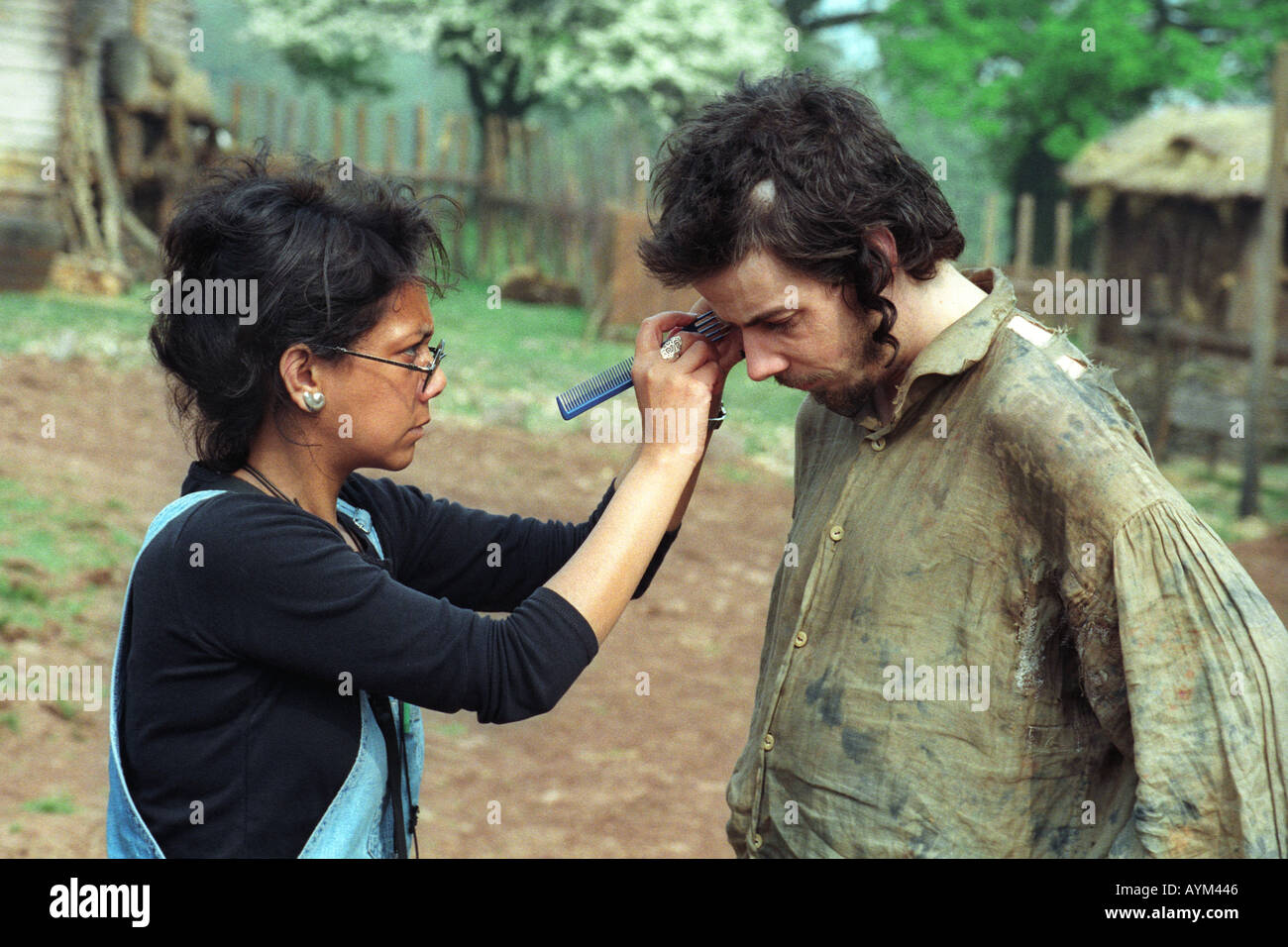 Makeup artist adjusting actor Noah Taylor's hair on the filmset of 'Simon Magus' being shot near Llangynidr Powys South Wales UK Stock Photo