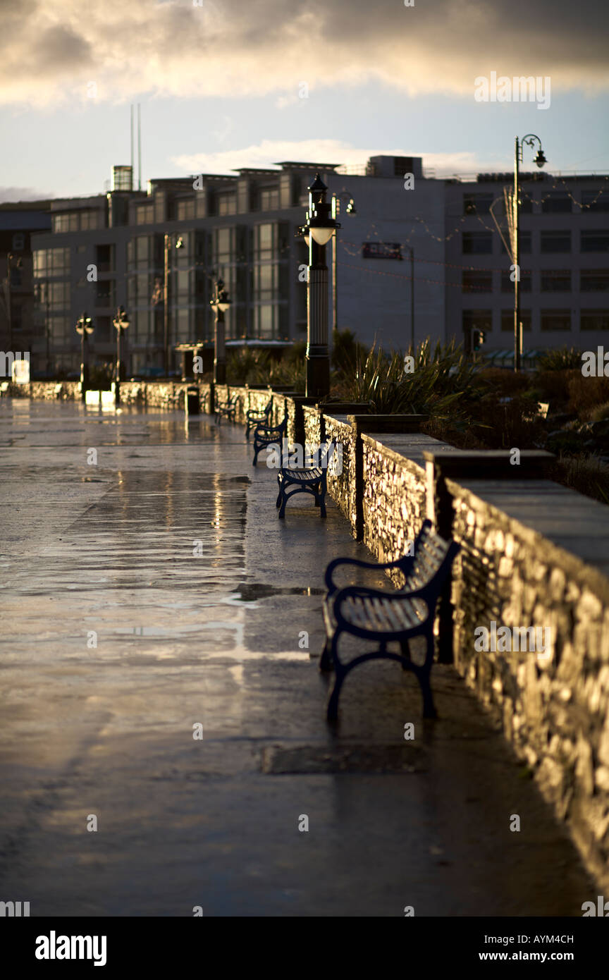 Seaside promenade caught in the early morning light following a rain shower Stock Photo