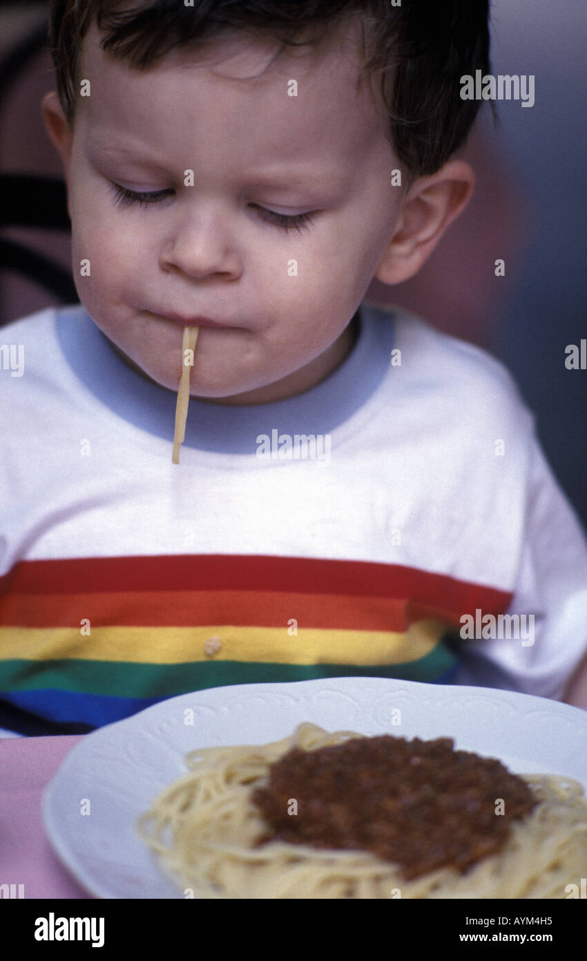 a young boy eating spaghetti bolognese Stock Photo