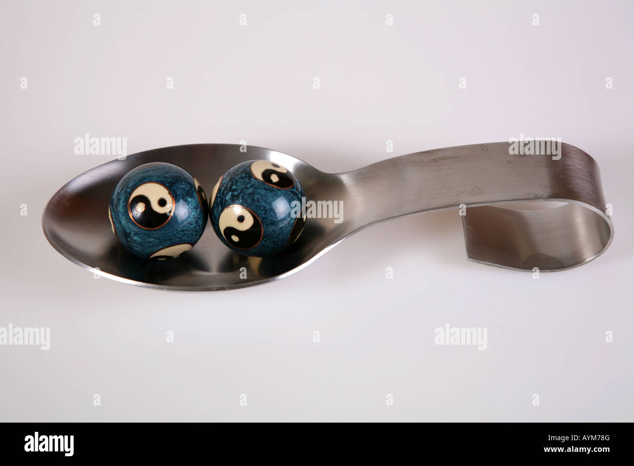 Yin and Yang Balls in a spoon Stock Photo