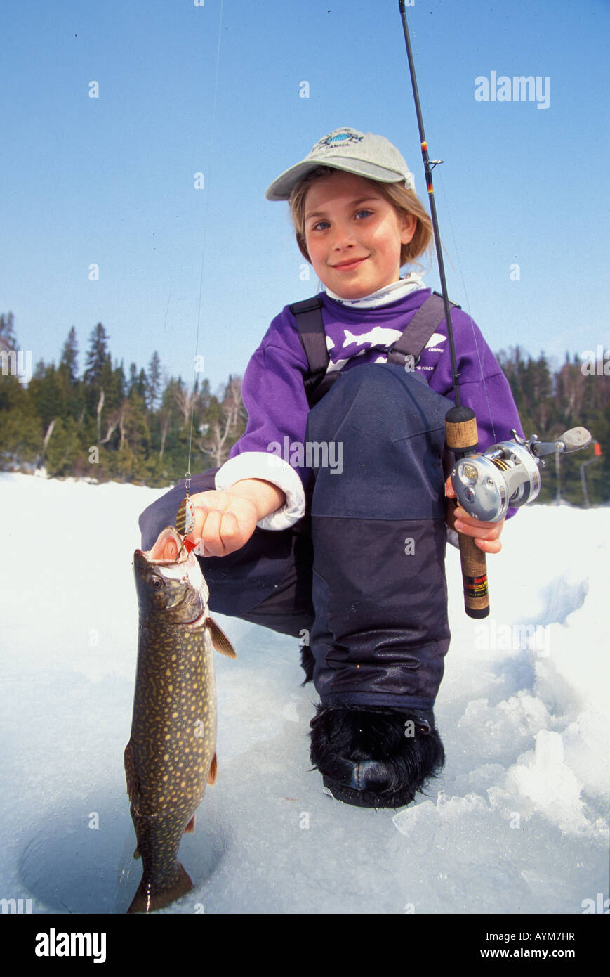 Young girl with Lake trout caught from Northern Ontario Lake Stock