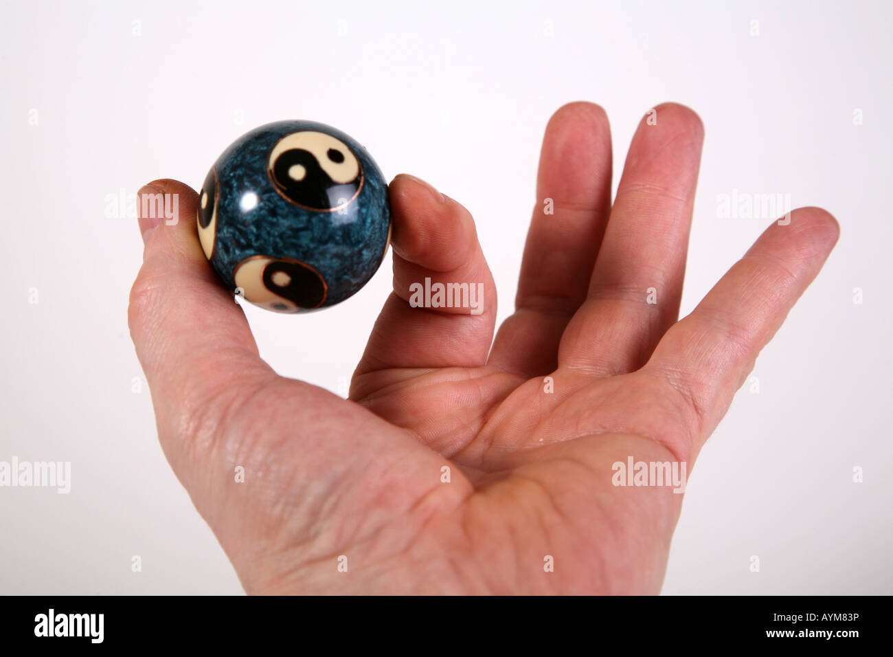 Hand holding Yin and Yang Ball Stock Photo