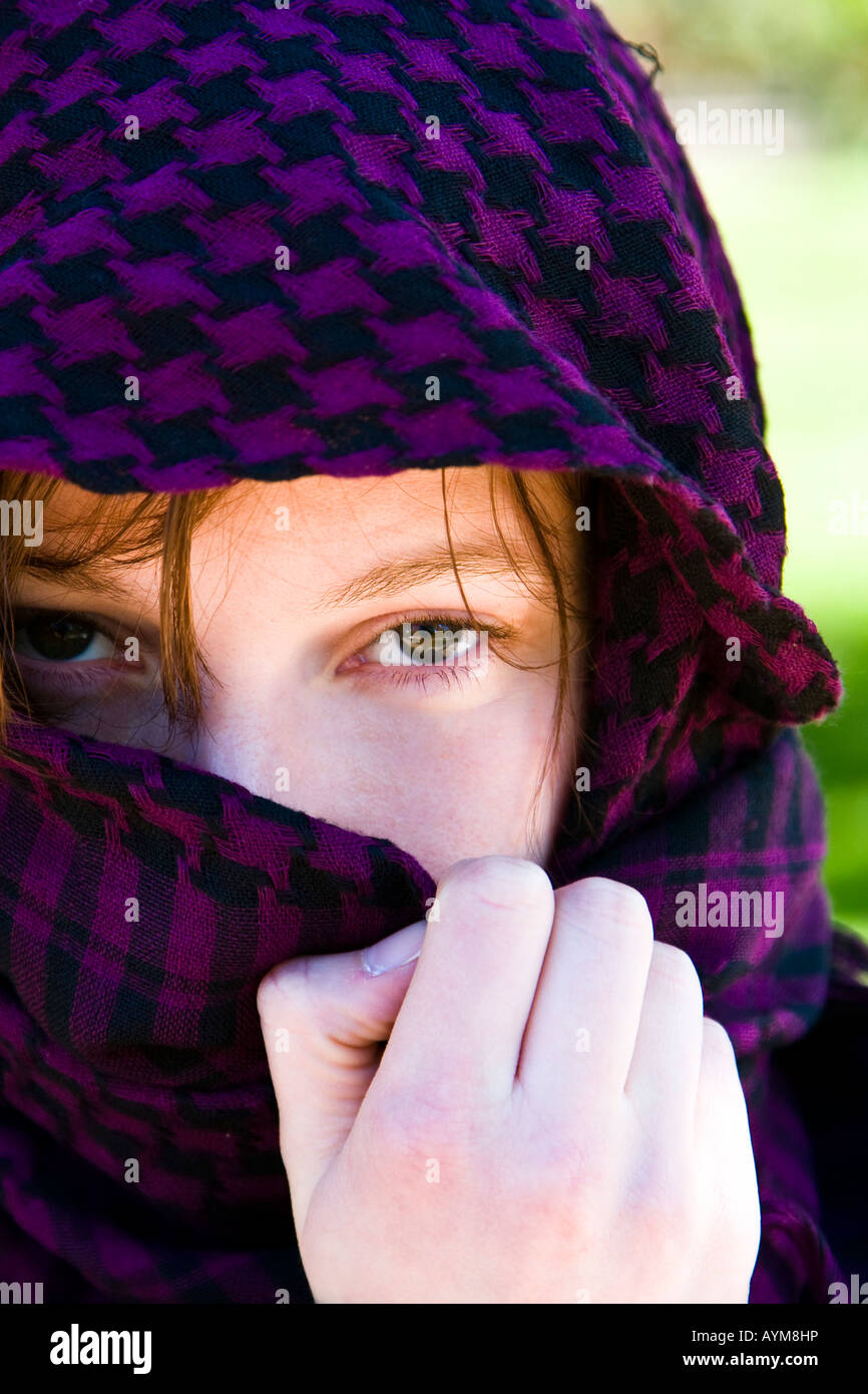 Staring woman portrait covered by violet veil Stock Photo