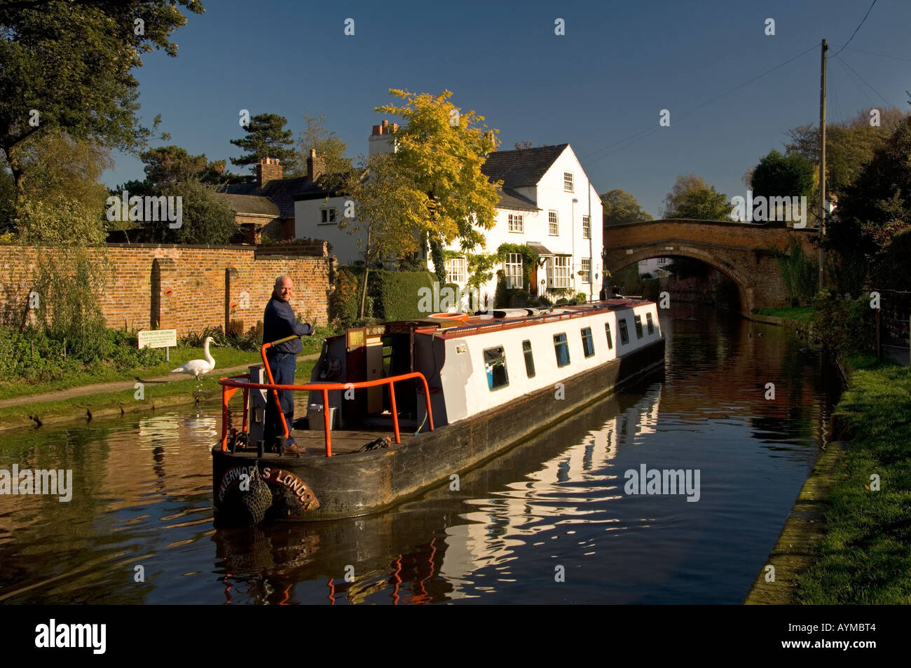 Canal Boat Passing Bridgewater House Reflected in the Bridgewater Canal, Lymm, Cheshire, England, UK Stock Photo