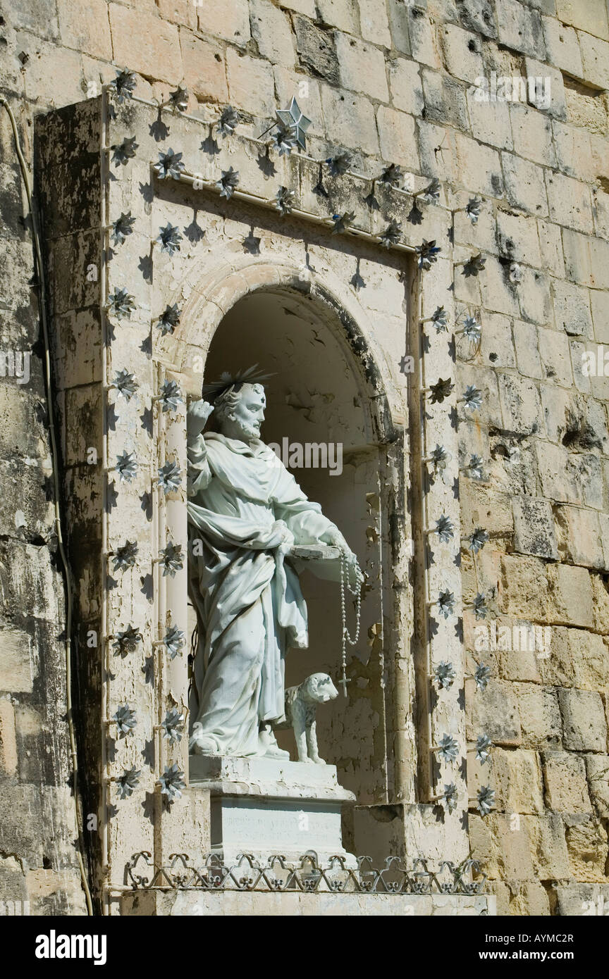 Religious statue set into a wall in Birgu, also Vittoriosa, Malta Stock