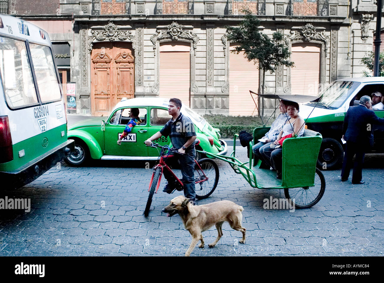 Methods of transport in Mexico City including green VW taxi rickshaw