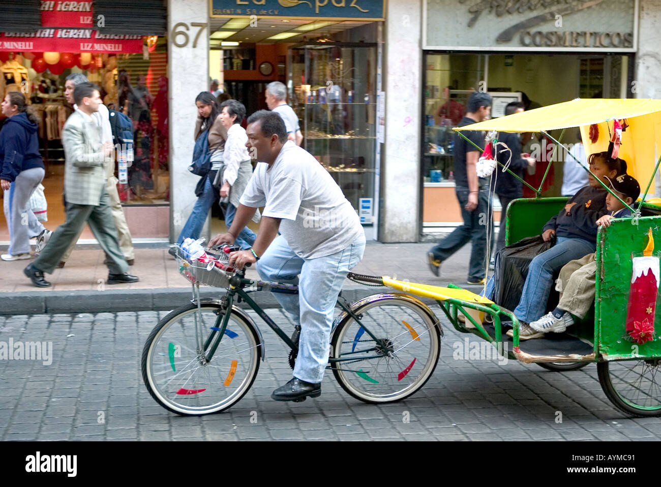 Rickshaw transport in Mexico City carrying woman and child Stock