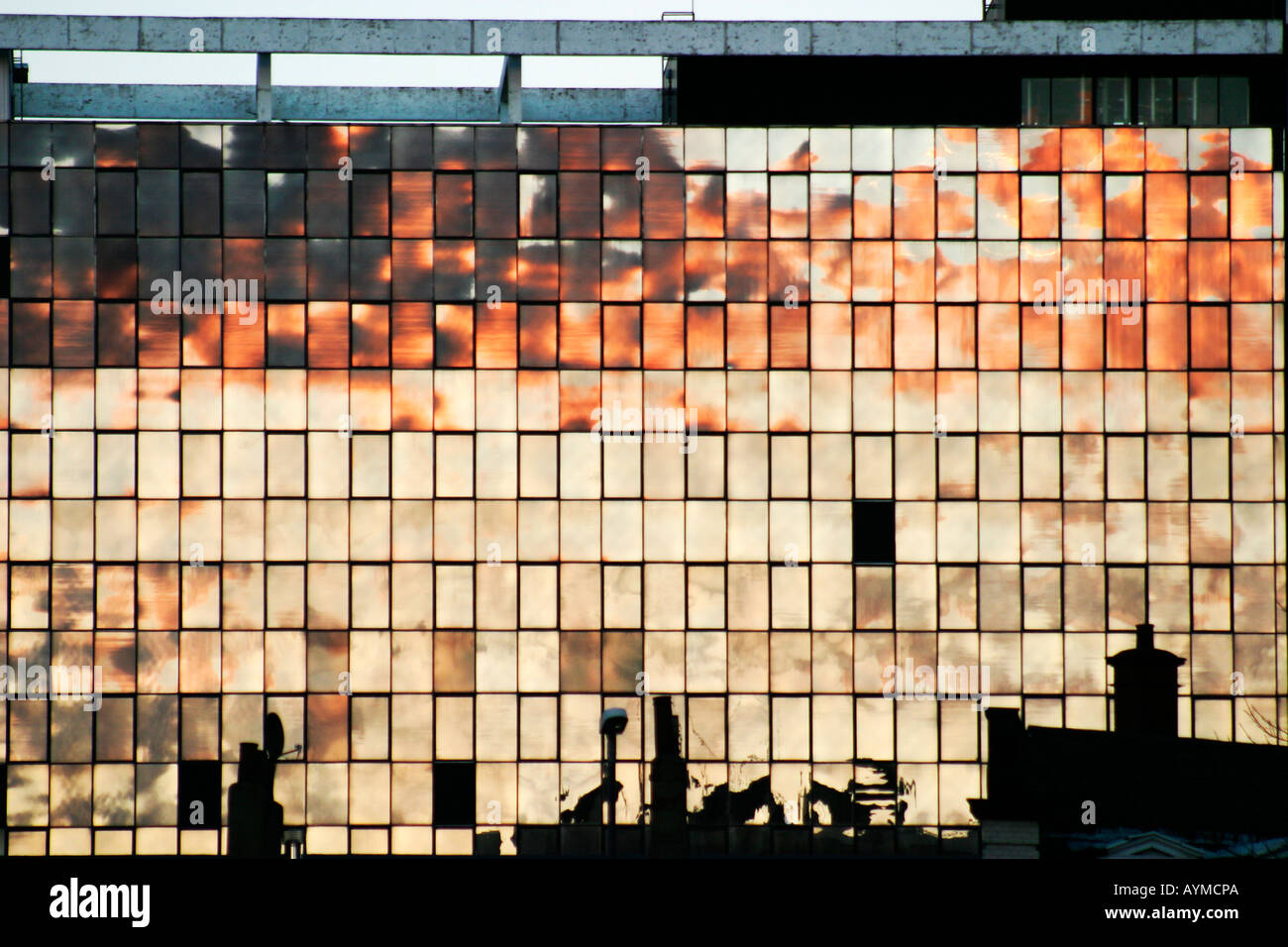 Sunset reflected in windows of office block Leeds centre Stock Photo ...