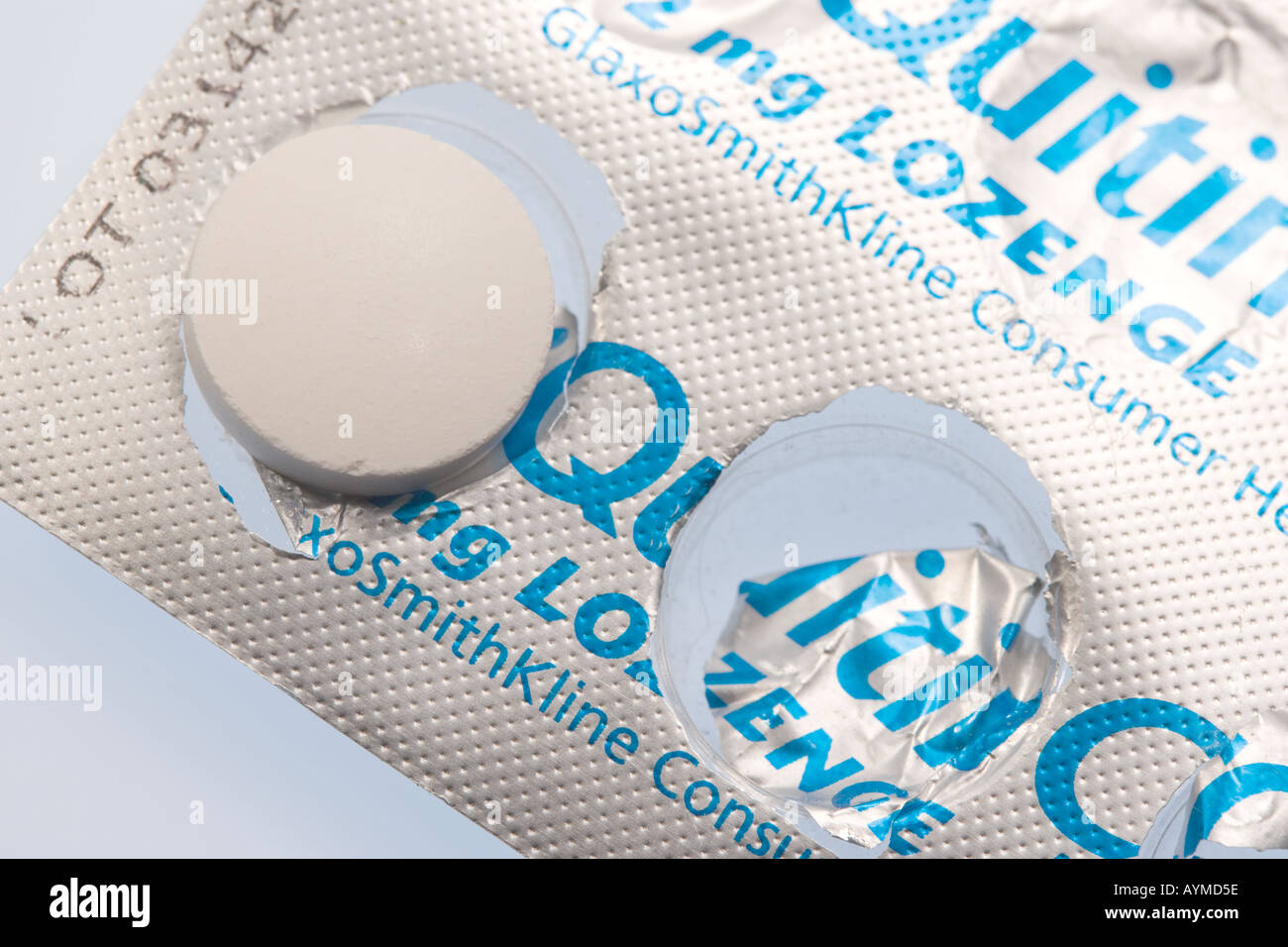 Nicotine replacement pill press through packet with pill on top Stock Photo