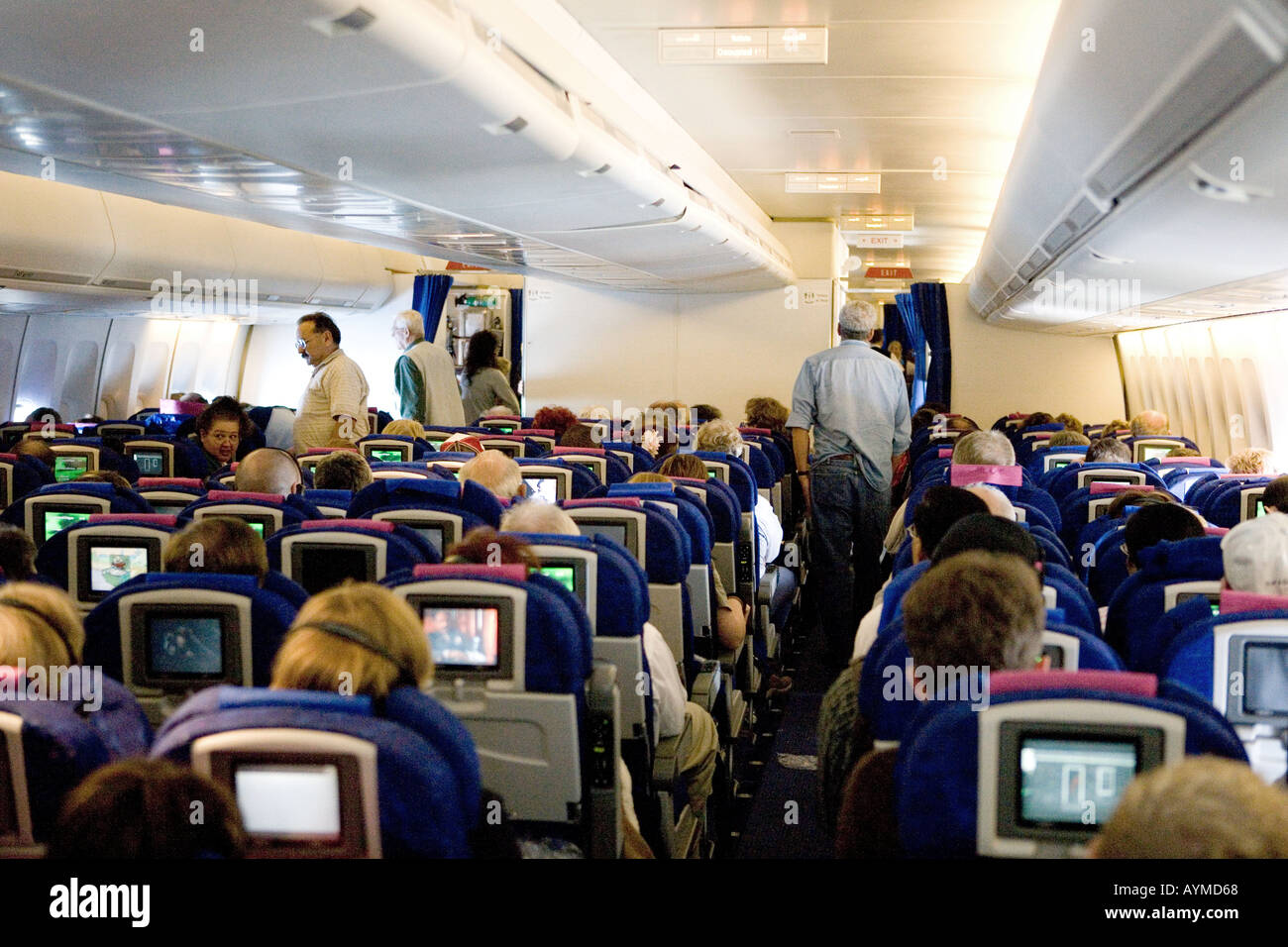 Economy cabin activity on a 747 aircraft during a trans atlantic flight Stock Photo