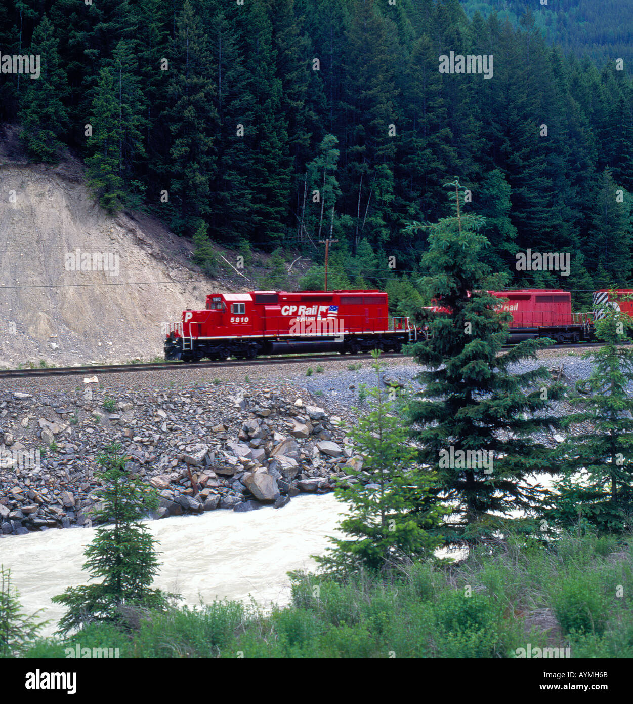 CP Rail freight train traveling along the Thompson River, Rocky Mountains, Canada. Photo by Willy Matheisl Stock Photo